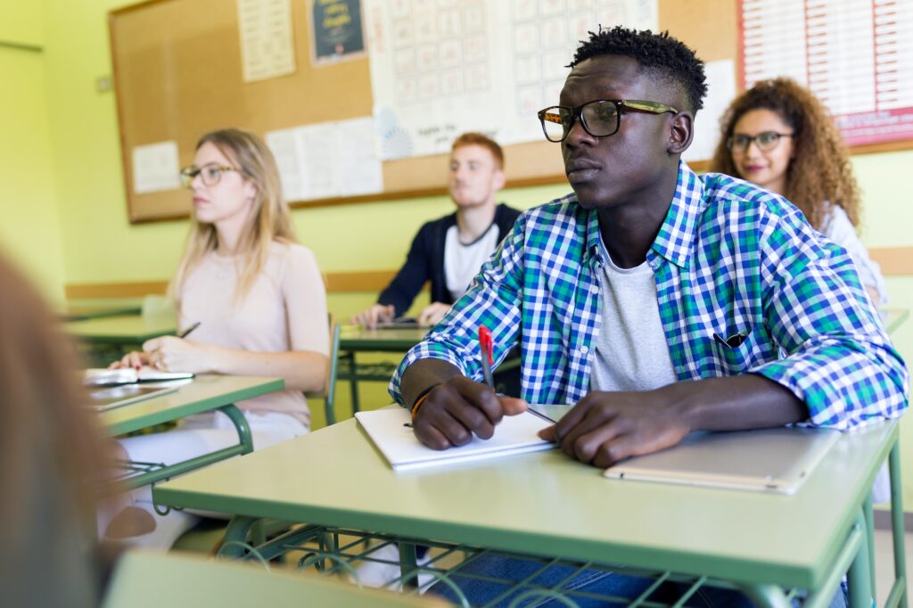 Group of friends studying in a university classroom.