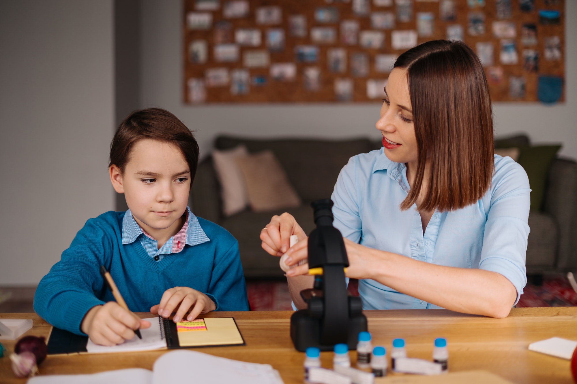 Home learning, woman and boy study at the table