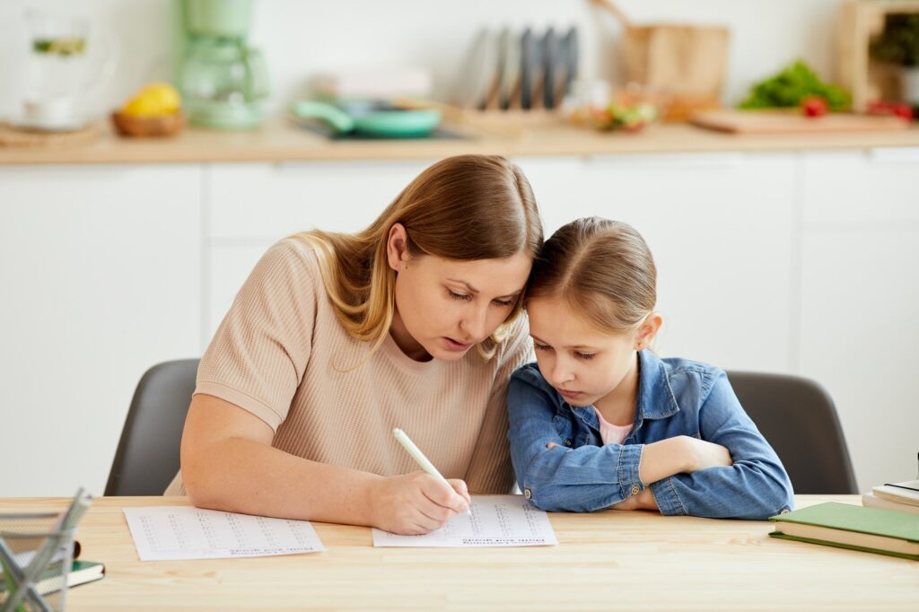 Mother Helping Daughter Studying at Home