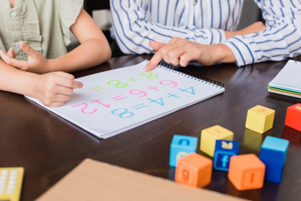 cropped shot of mother and daughter learning math