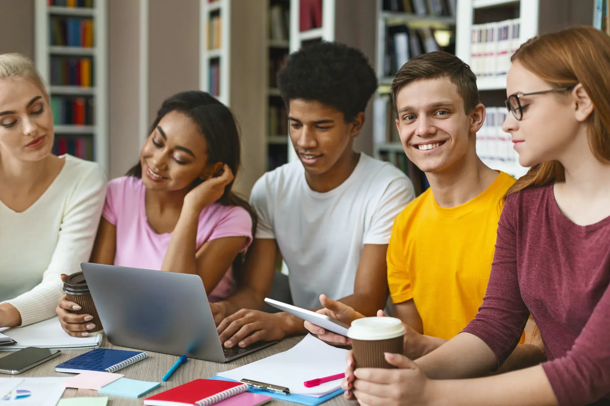 International students using laptop and tablet while studying